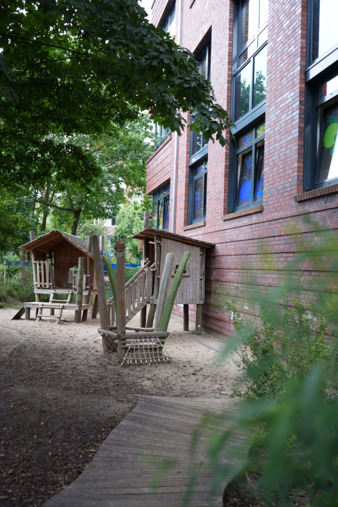 Außenbereich mit einem Spielplatz auf Holz in der Kita kinderzimmer Marmelade in Hamburg Othmarschen